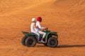 Quad Biking Dubai Adventure Tour Ã¢â¬â Young copule of tourists having fun on Quad Bike Riding in dunes of Dubai Royalty Free Stock Photo